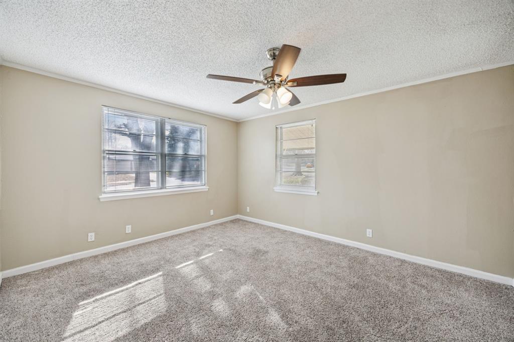 2017 Durham Street Irving, TX 75062 - Photo 23 of 26 an empty room with windows and fan
