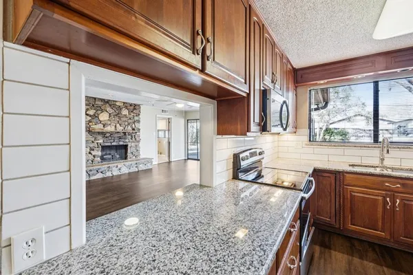a view of a kitchen with a sink and cabinets