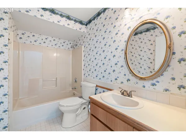 a bathroom with a sink a toilet and a mirror