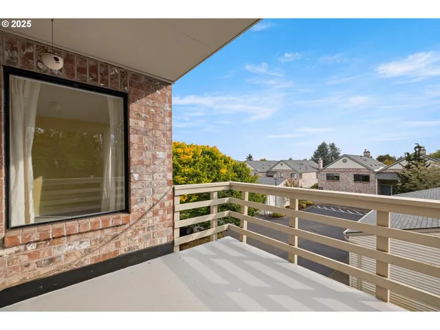 a view of a balcony with wooden floor and city view
