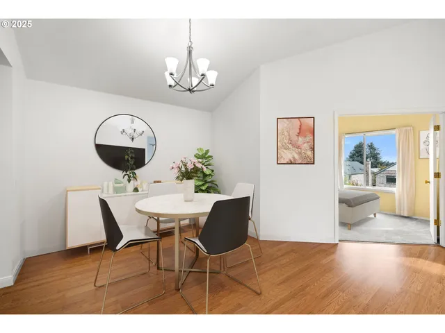 a view of a dining room with furniture and chandelier