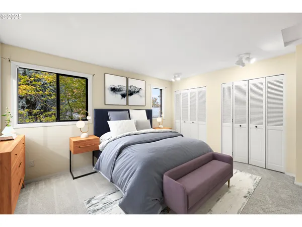 a bedroom with a large bed and a large window