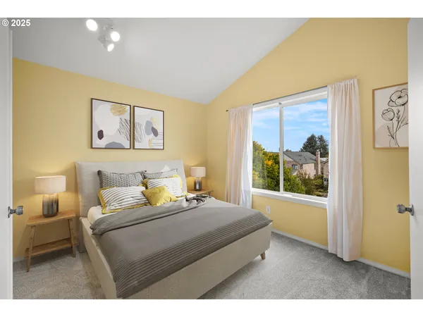 a bedroom with a bed and a painting on the wall