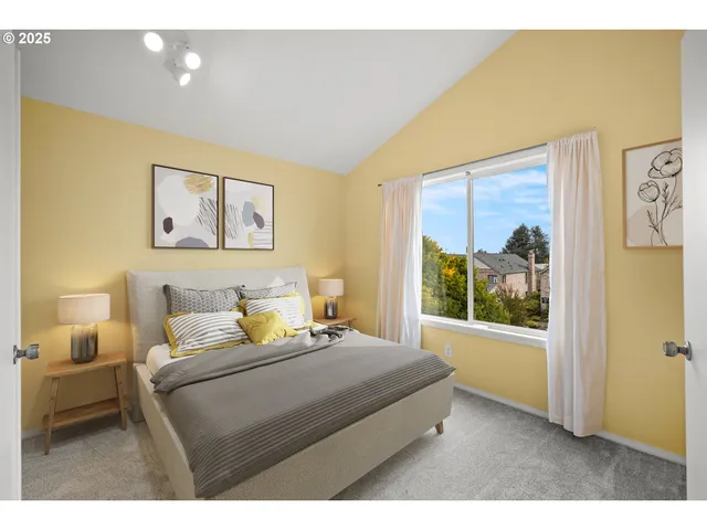 a bedroom with a bed and a painting on the wall