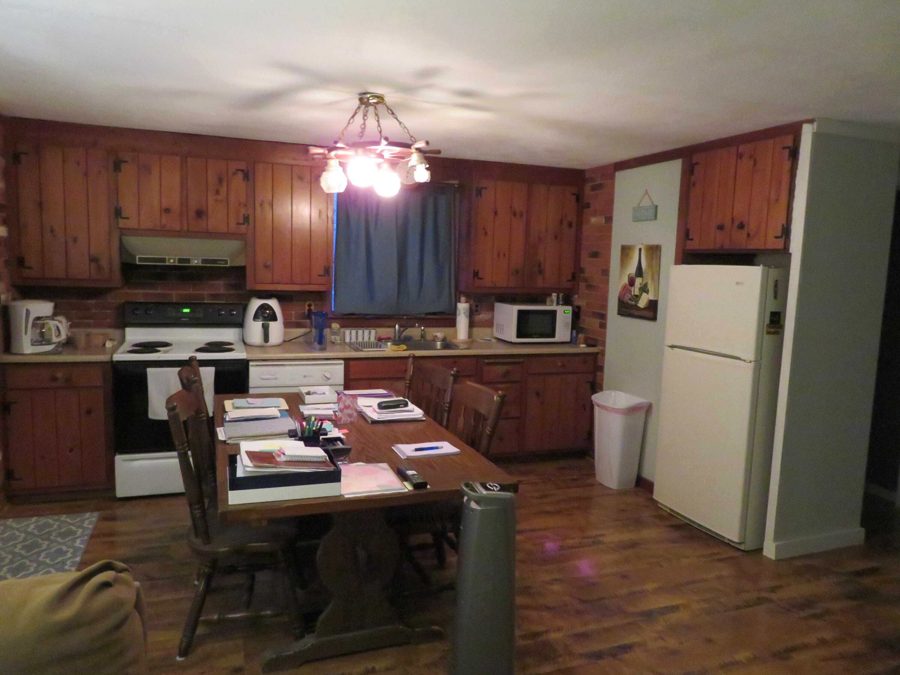 65 Clayton Road Eastham, MA 02642 - Photo 3 of 12 a kitchen with refrigerator a stove a microwave a sink and cabinets