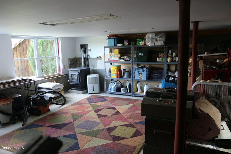37 Russell Road Huntington, MA 01050 - Photo 22 of 22 a bed room with a bed a couch and a window