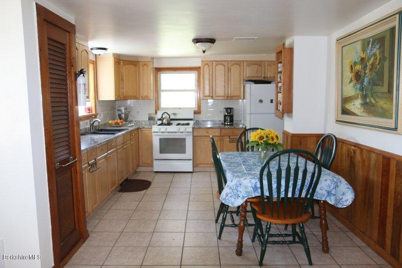 37 Russell Road Huntington, MA 01050 - Photo 8 of 22 a kitchen with a dining table chairs and stainless steel appliances