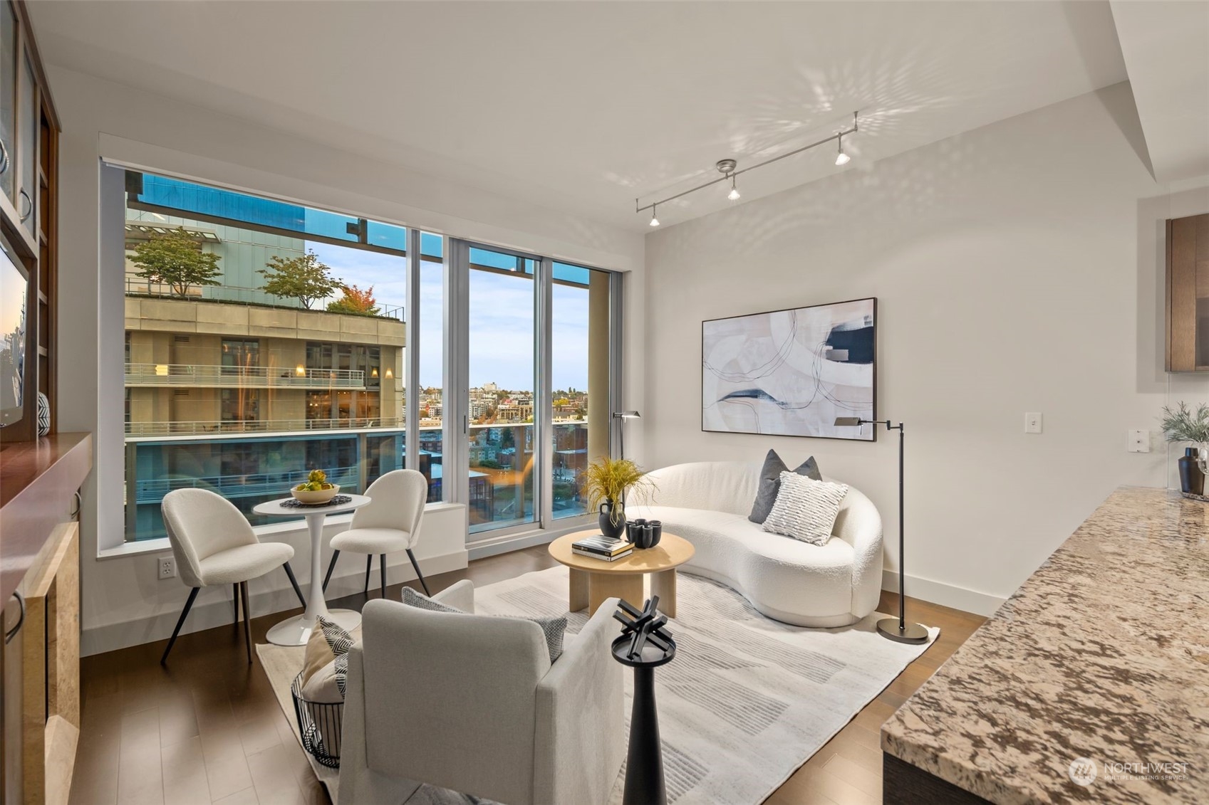 737 Olive Way, Unit 2503 Seattle, WA 98101 - Photo 11 of 29 a living room with furniture and a large window