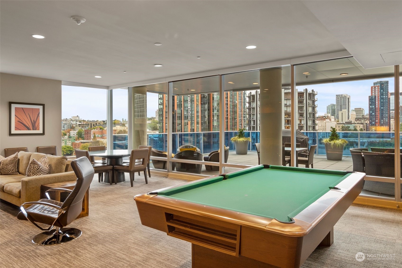 737 Olive Way, Unit 2503 Seattle, WA 98101 - Photo 19 of 29 a room with furniture and a floor to ceiling window