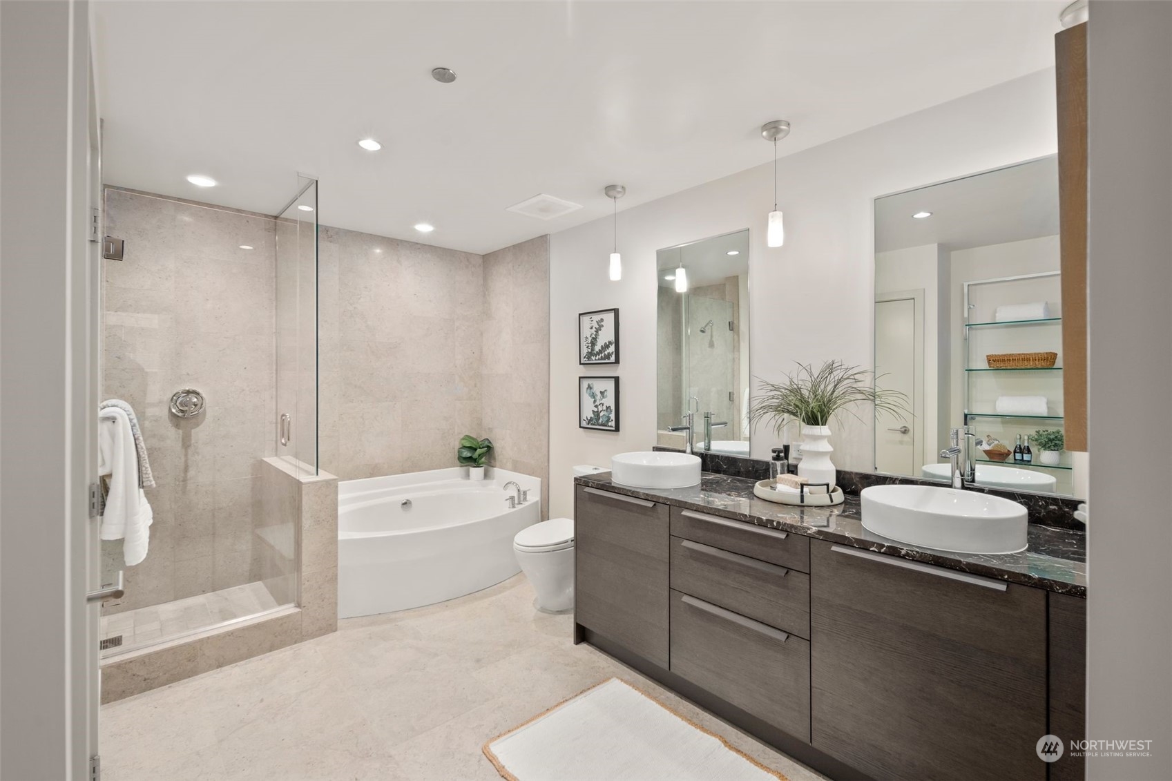 737 Olive Way, Unit 2503 Seattle, WA 98101 - Photo 4 of 29 a large bathroom with a double vanity sink a large mirror and shower