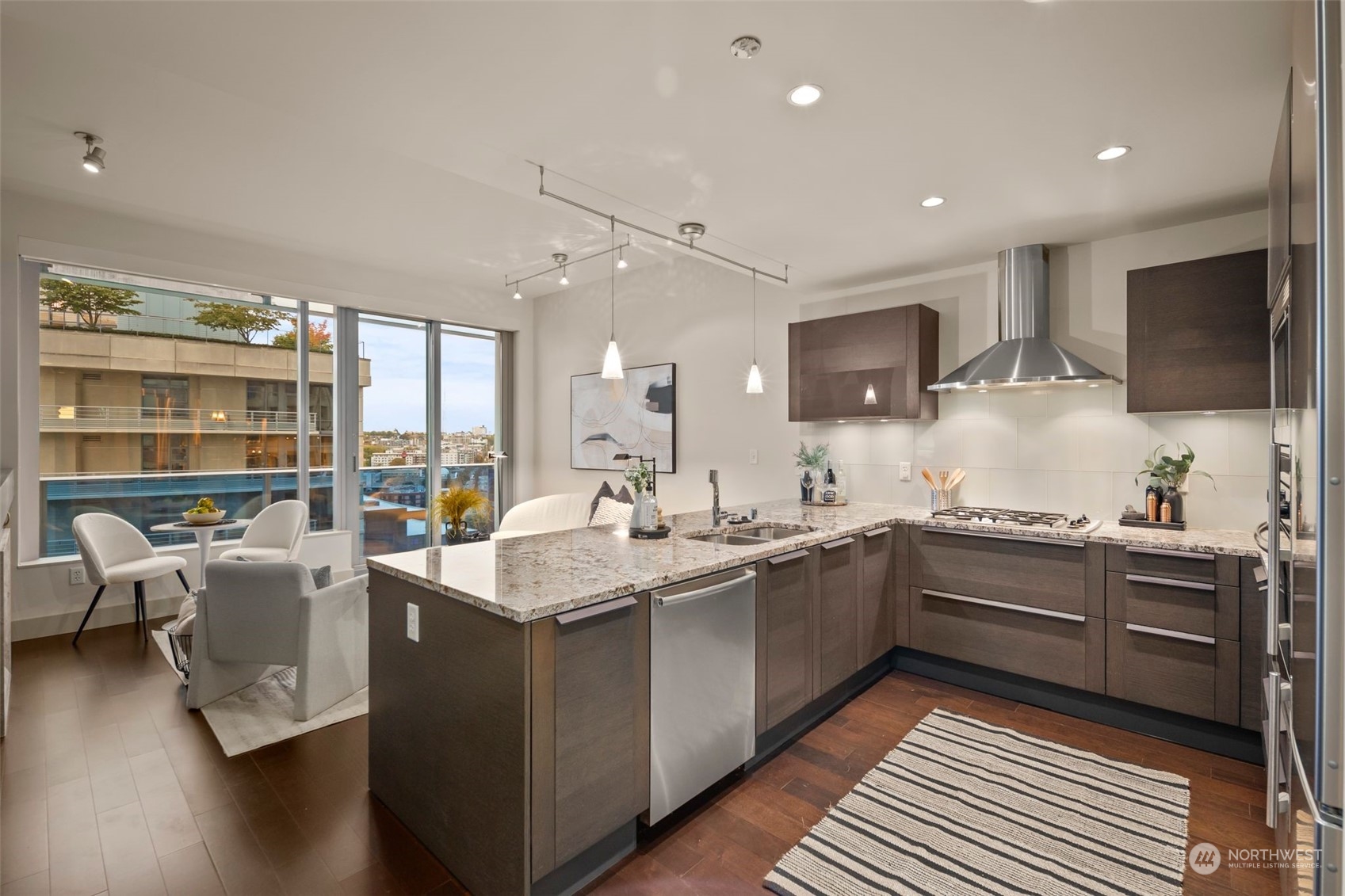 737 Olive Way, Unit 2503 Seattle, WA 98101 - Photo 5 of 29 a large kitchen with stainless steel appliances lots of counter space and a sink