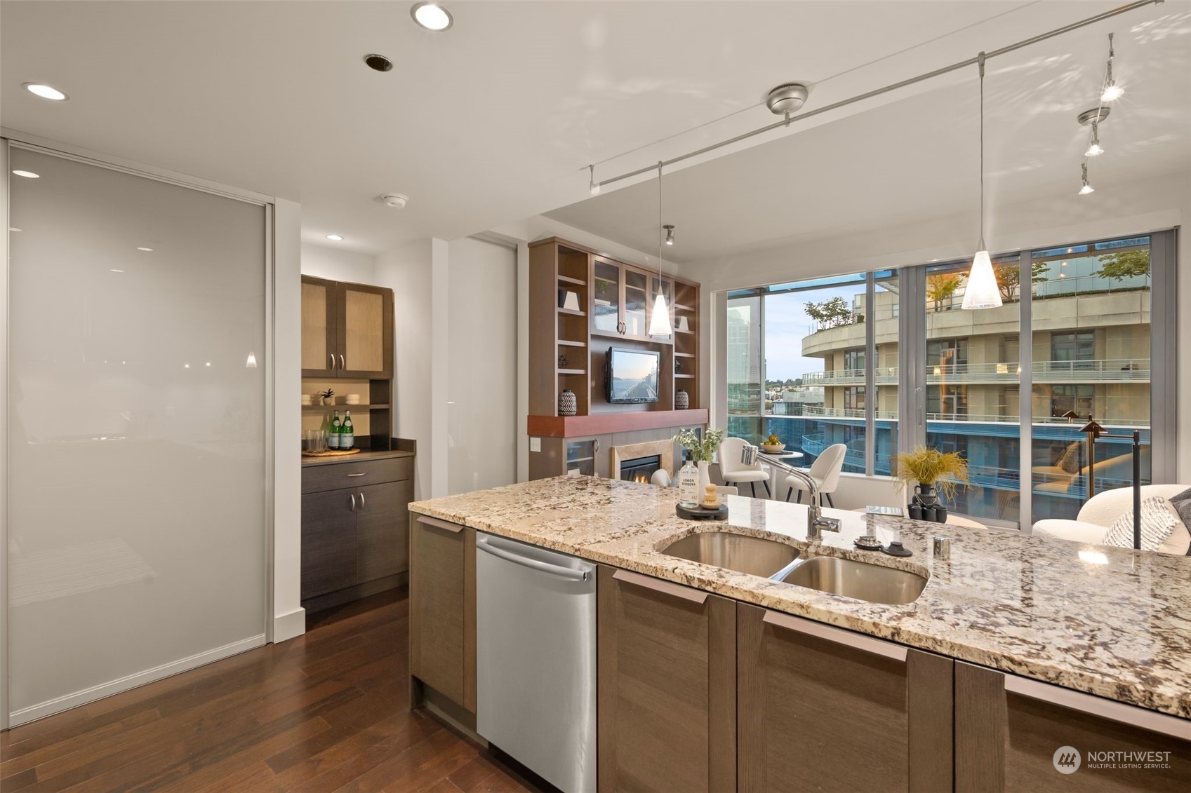 737 Olive Way, Unit 2503 Seattle, WA 98101 - Photo 6 of 29 a kitchen with stainless steel appliances granite countertop a sink and dishwasher with wooden floor