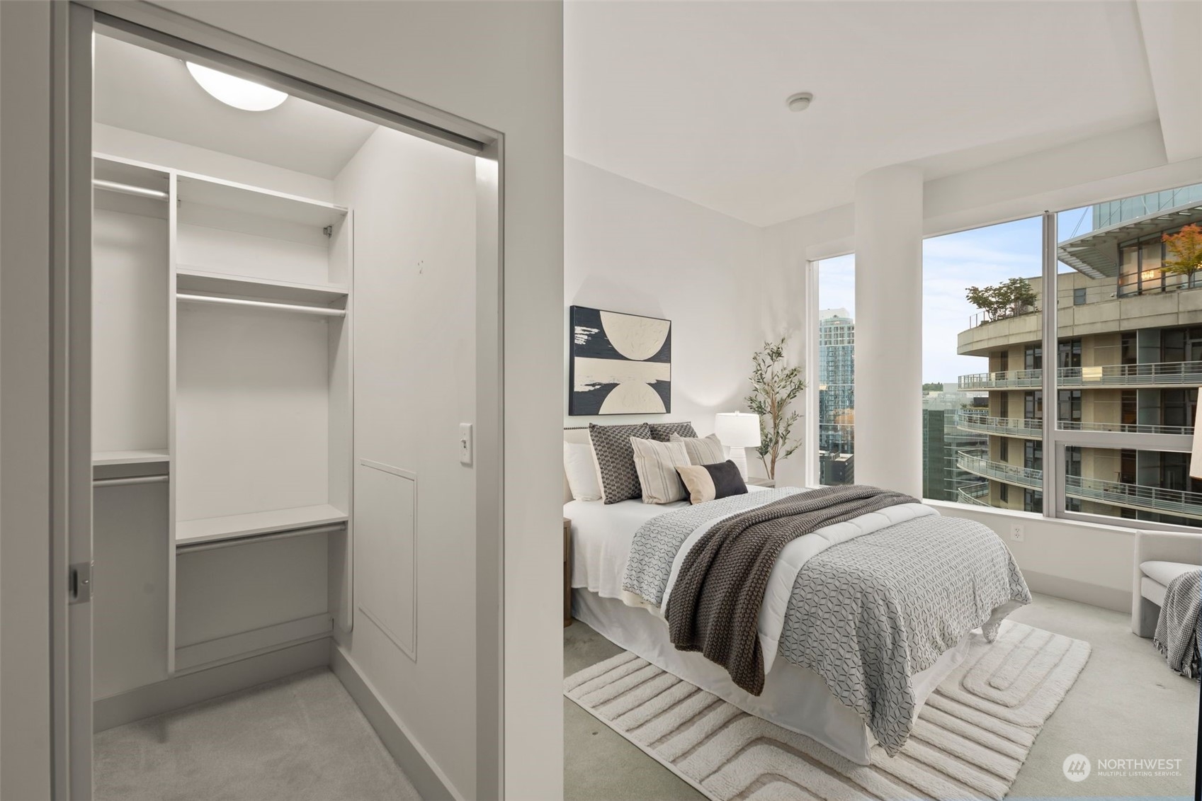 737 Olive Way, Unit 2503 Seattle, WA 98101 - Photo 8 of 29 a bedroom with a bed and a large mirror