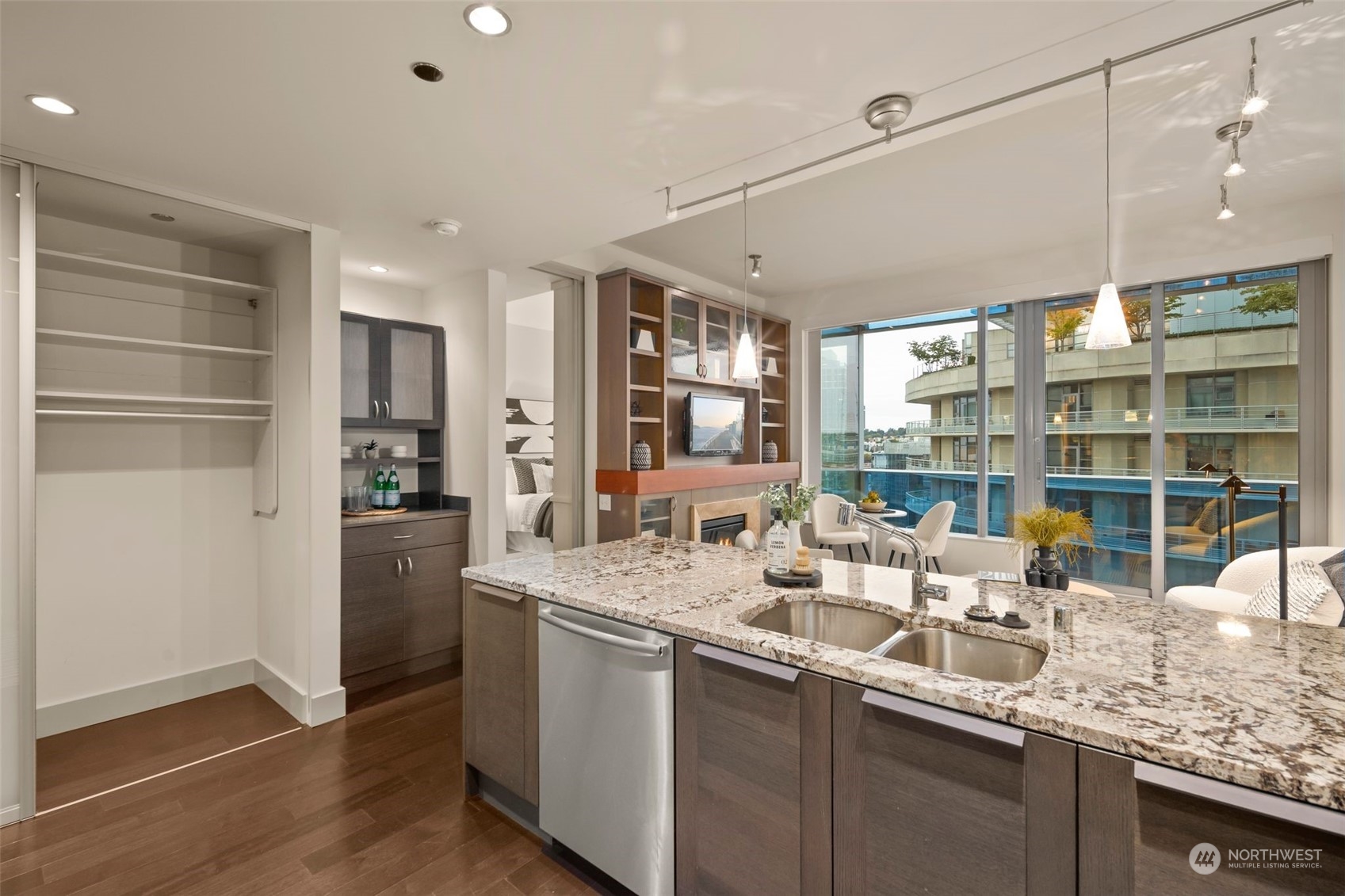 737 Olive Way, Unit 2503 Seattle, WA 98101 - Photo 10 of 29 a kitchen with stainless steel appliances granite countertop a sink and wooden cabinets