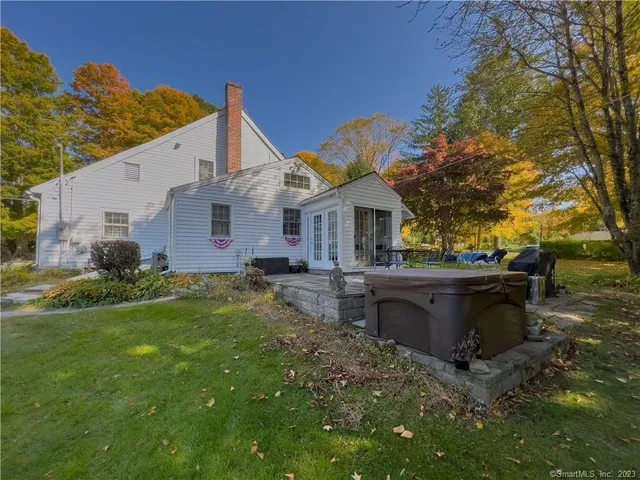 a view of a house with a backyard and a patio