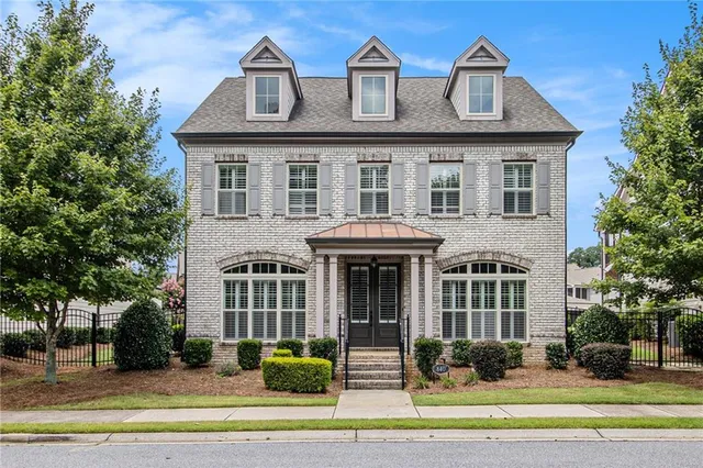 a front view of a residential apartment building with a yard
