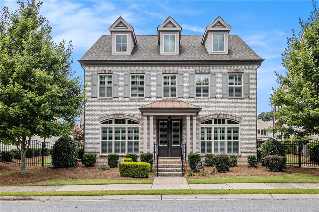 a front view of a residential apartment building with a yard