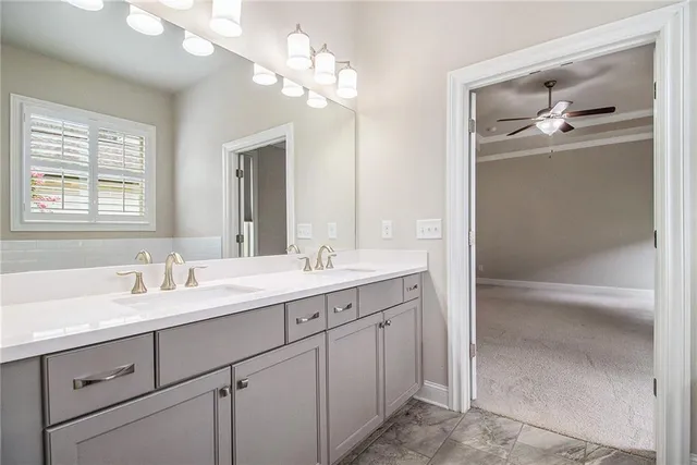 a bathroom with a sink a toilet and mirror