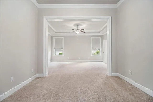 en empty room with ceiling fan and window