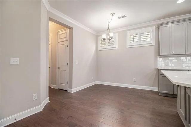 an empty room with windows and entrance