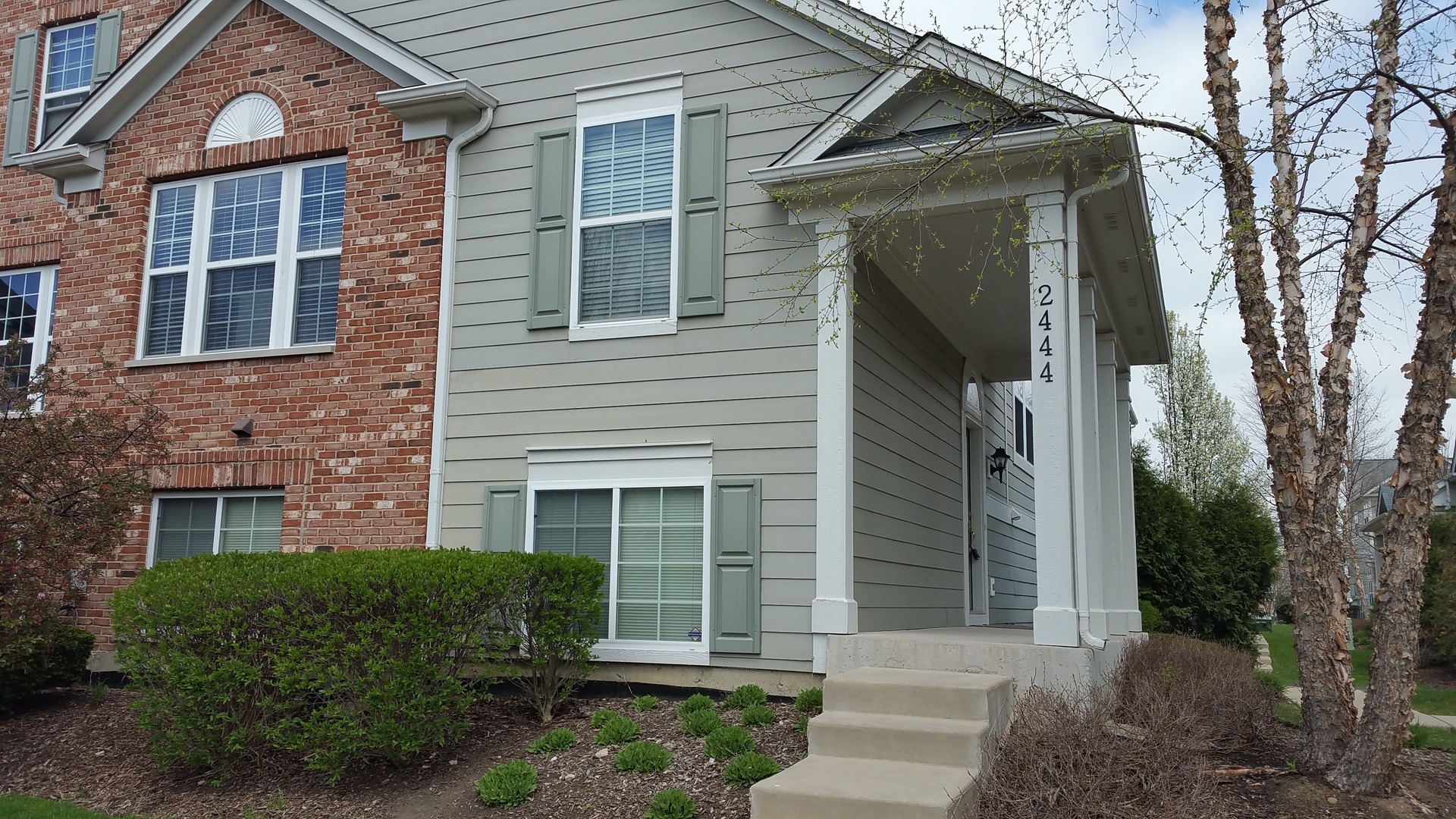 2444 Emily Lane, Unit 2444 Elgin, IL 60124 - Photo 1 of 22 a front view of a house with a yard