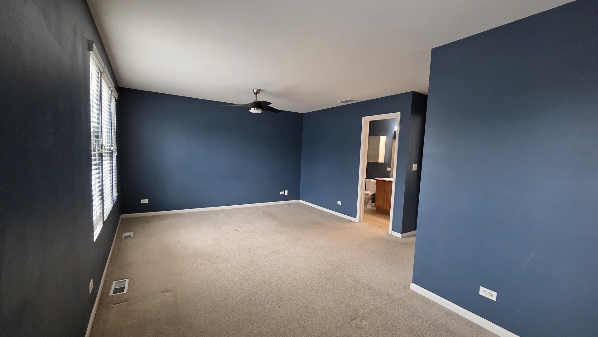 2444 Emily Lane, Unit 2444 Elgin, IL 60124 - Photo 7 of 22 a view of an empty room with window and wooden floor