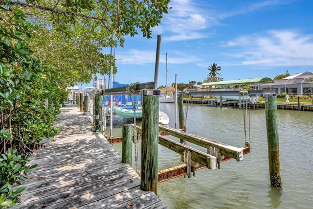 a view of a lake with boats in front of house