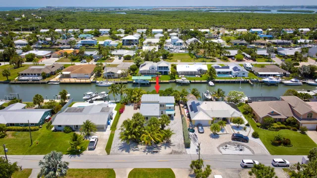 an aerial view of residential houses with outdoor space and swimming pool