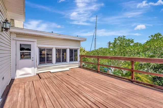 a view of a balcony with wooden floor