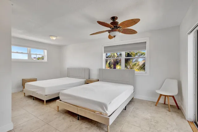 a bedroom with a bed a window and a chandelier