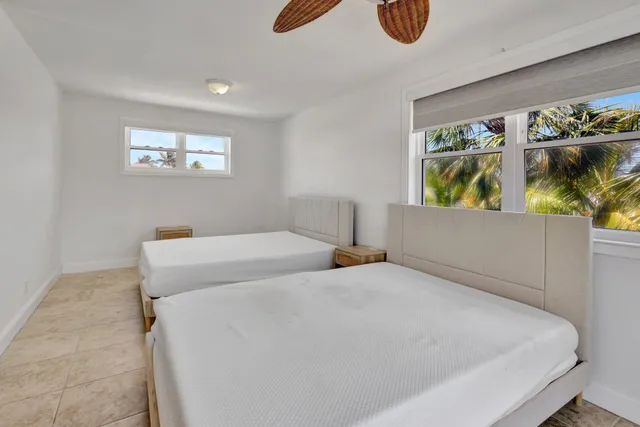 a bedroom with a bed and painting on the wall