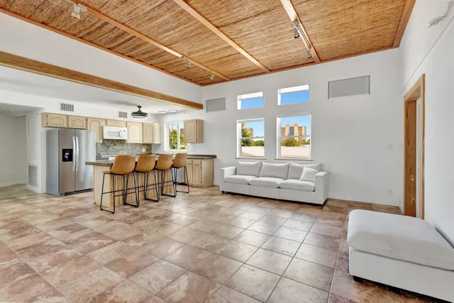 a living room with furniture and a dining table