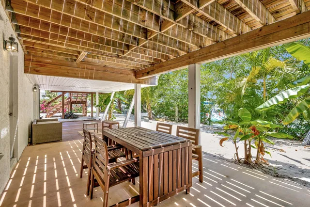 a view of a patio with table and chairs and wooden floor