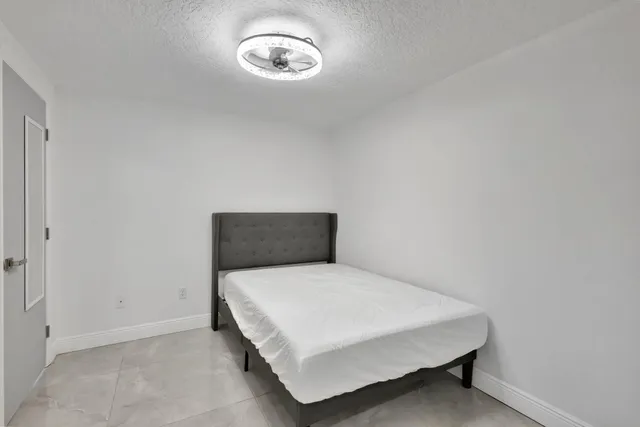 a bedroom with a bed and a table
