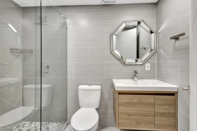 a bathroom with a sink toilet and shower