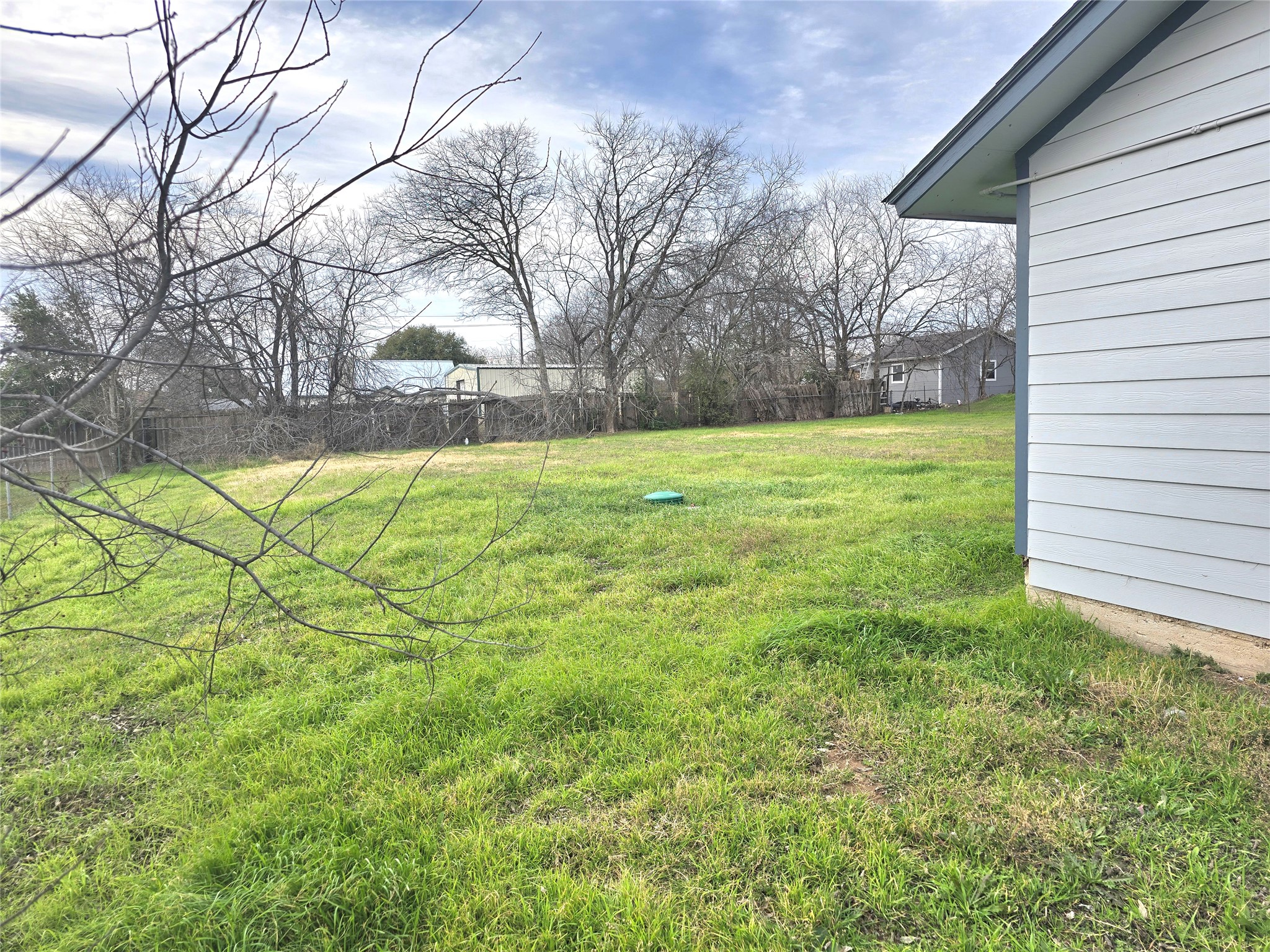15208 Spring Hill Lane, Unit A Pflugerville, TX 78660 - Photo 16 of 16 Expansive grassy yard with a fenced perimeter and mature trees