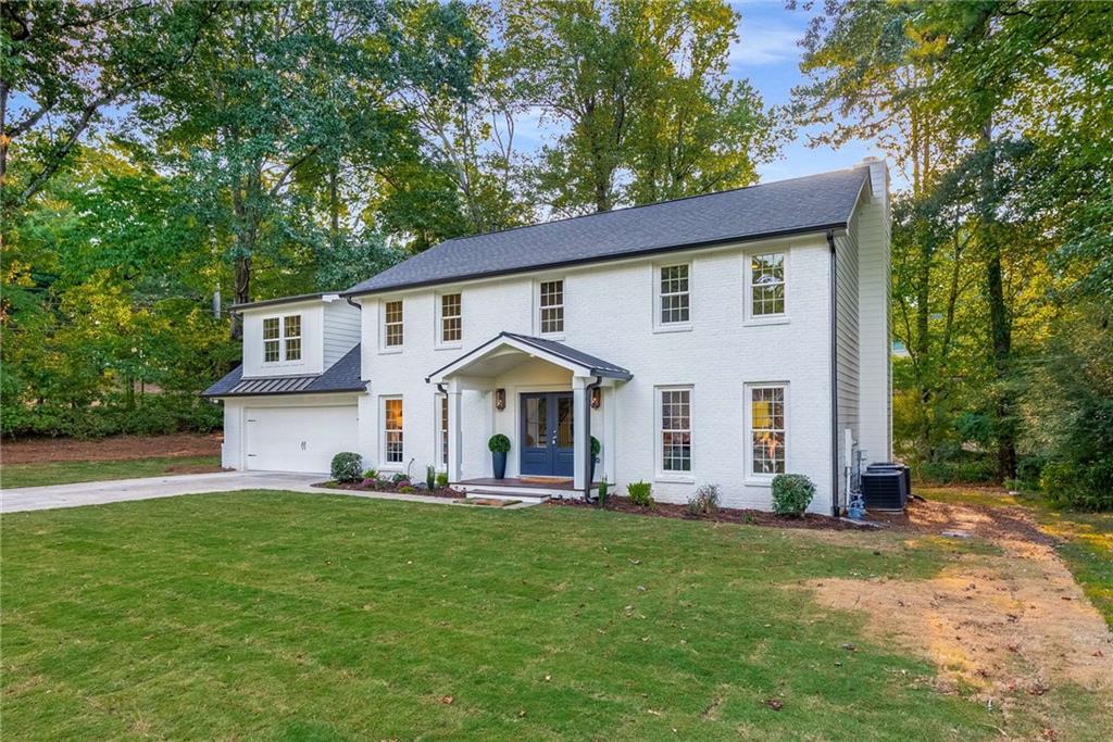 a front view of house with yard and green space