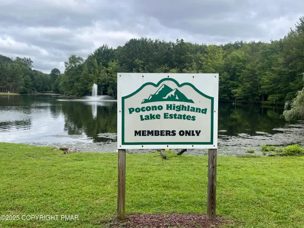 a sign on the side of the river