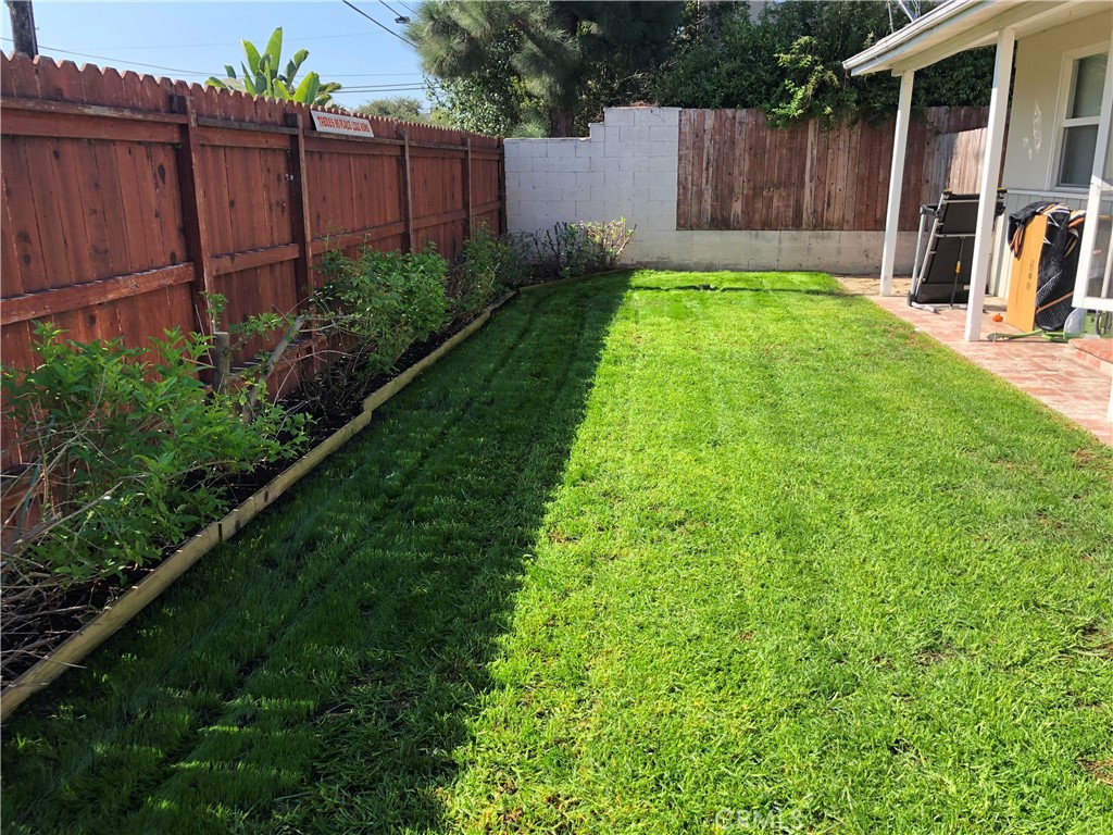 Undisclosed Address Costa Mesa, CA 92627 - Photo 14 of 16 a view of a backyard with potted plants and wooden fence