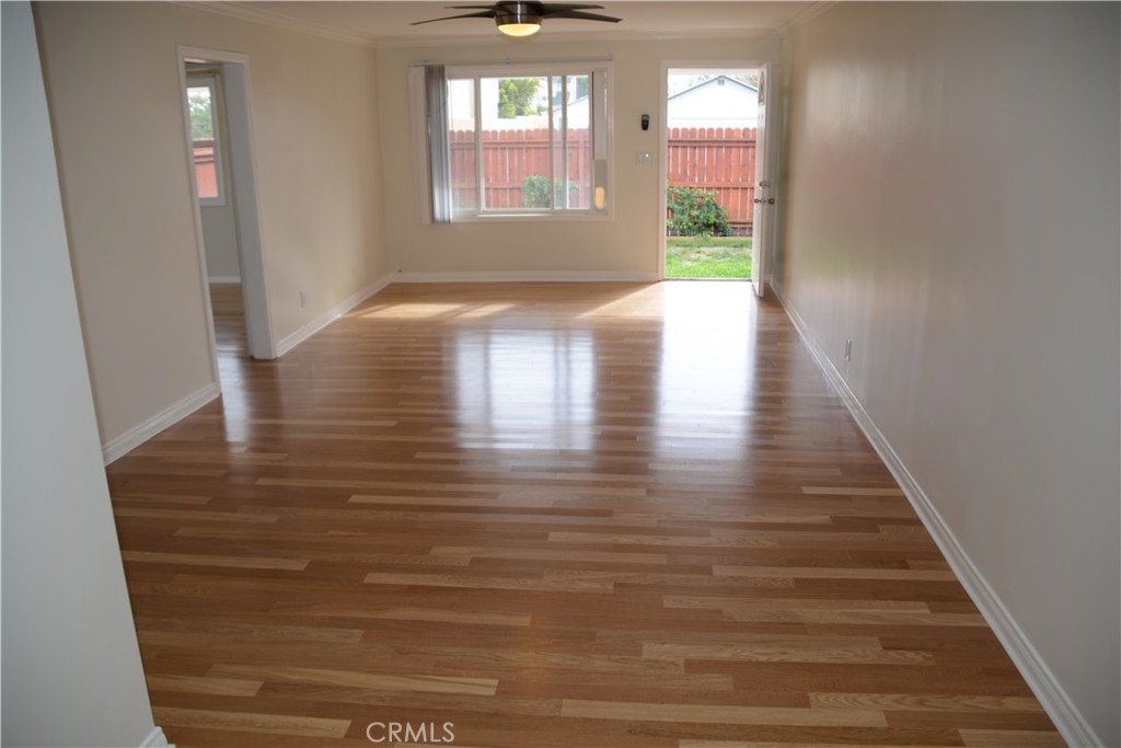 Undisclosed Address Costa Mesa, CA 92627 - Photo 10 of 16 a view of a hallway with wooden floor and a floor to ceiling window
