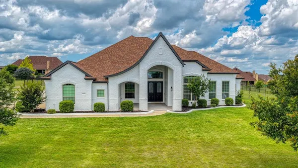 a front view of house with yard and green space