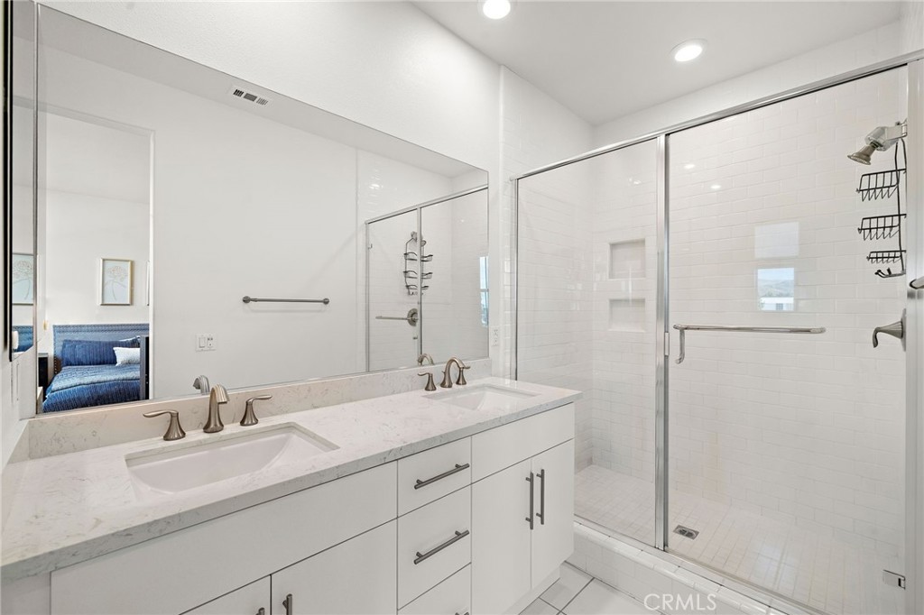 144 Paramount Irvine, CA 92618 - Photo 16 of 43 a bathroom with a double vanity sink mirror and shower