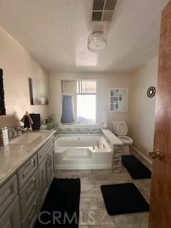 a spacious bathroom with a sink a mirror and a bathtub