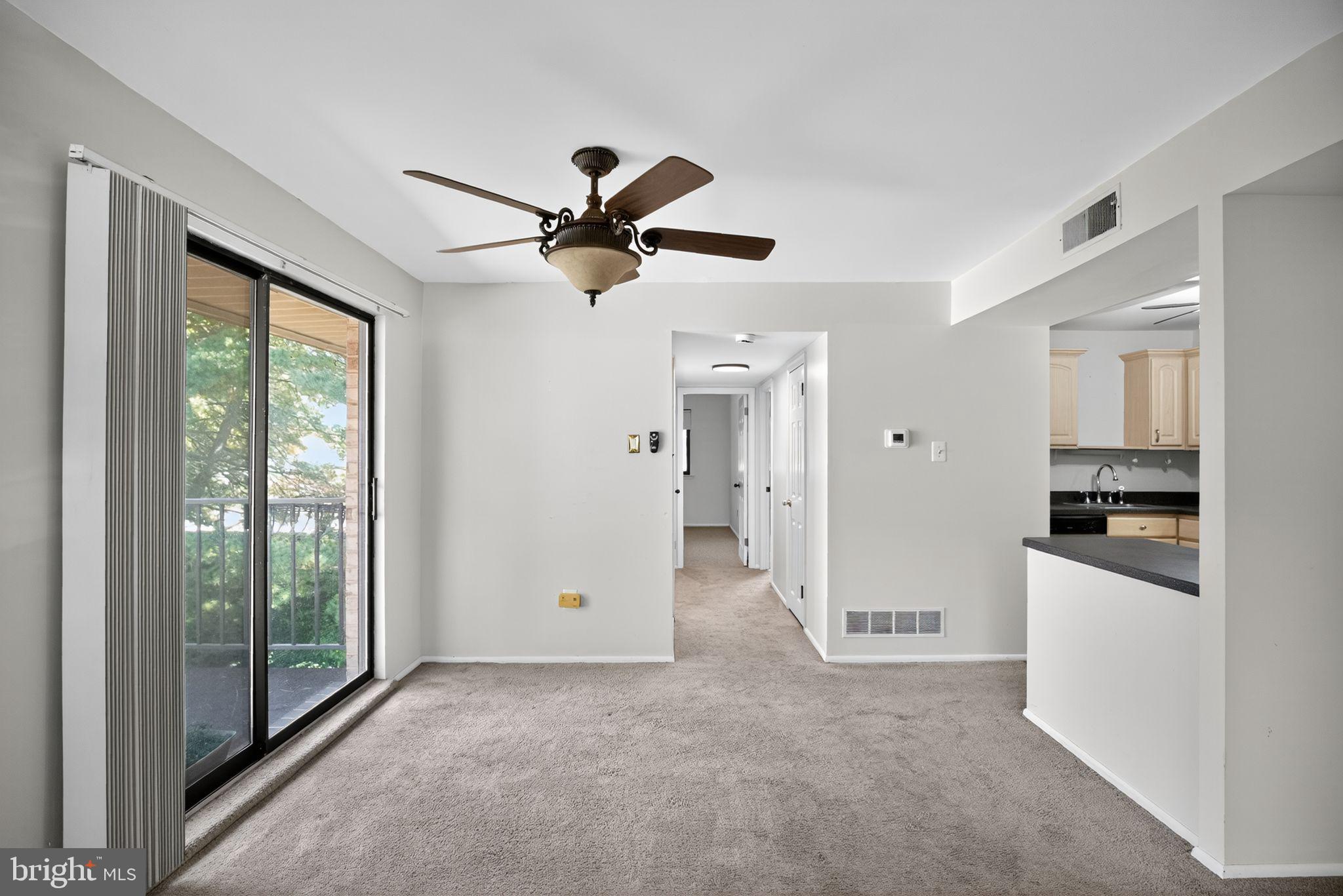 356 B Saybrook Lane, Unit B Wallingford, PA 19086 - Photo 11 of 34 a view of a room with a ceiling fan and a kitchen view