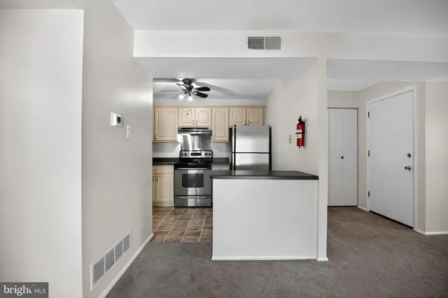 a kitchen with cabinets and stainless steel appliances