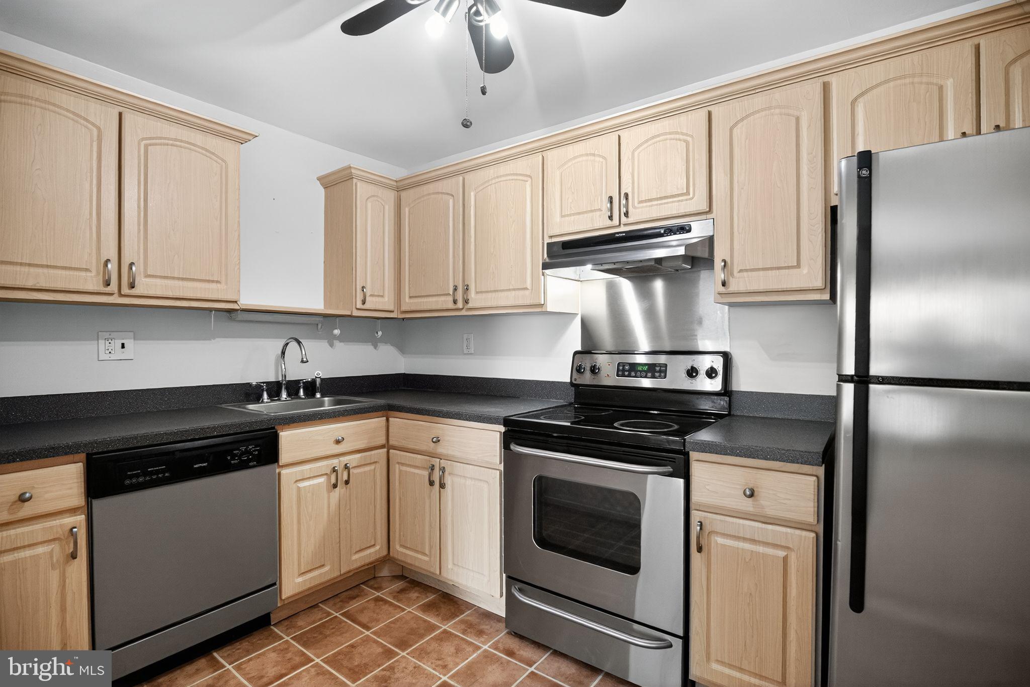 356 B Saybrook Lane, Unit B Wallingford, PA 19086 - Photo 14 of 34 a kitchen with cabinets stainless steel appliances and a counter space