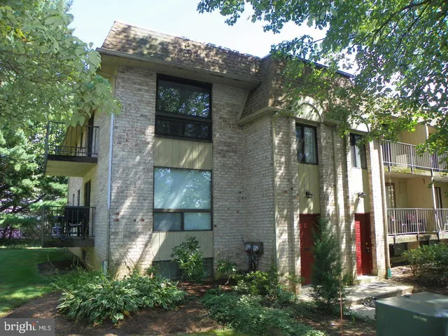 a front view of a house with plants