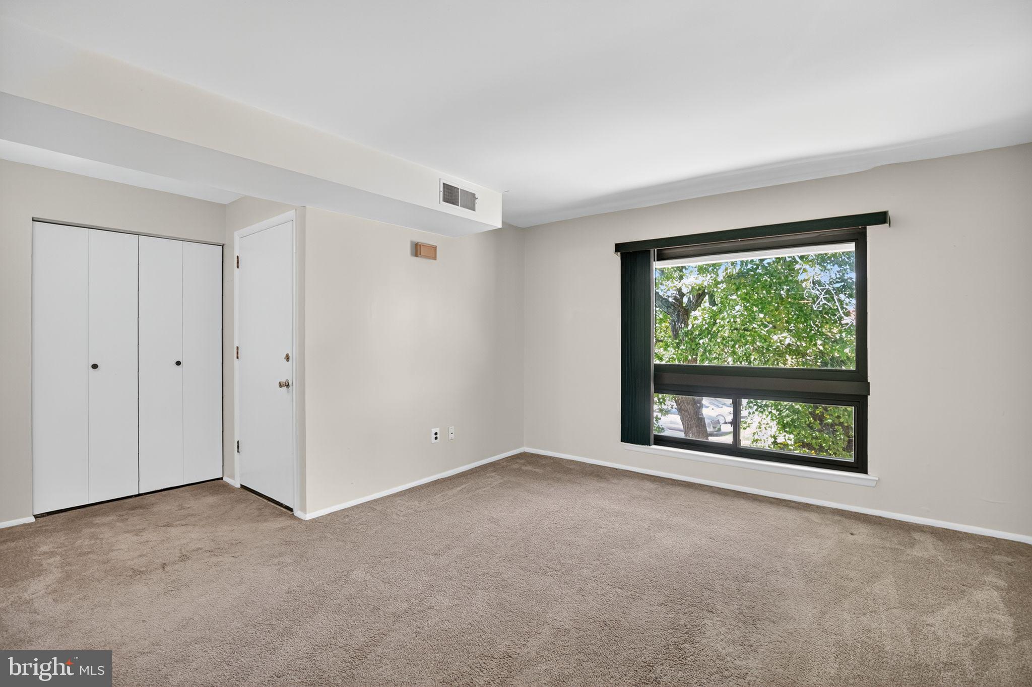 356 B Saybrook Lane, Unit B Wallingford, PA 19086 - Photo 5 of 34 a view of an empty room with a window and kitchen view