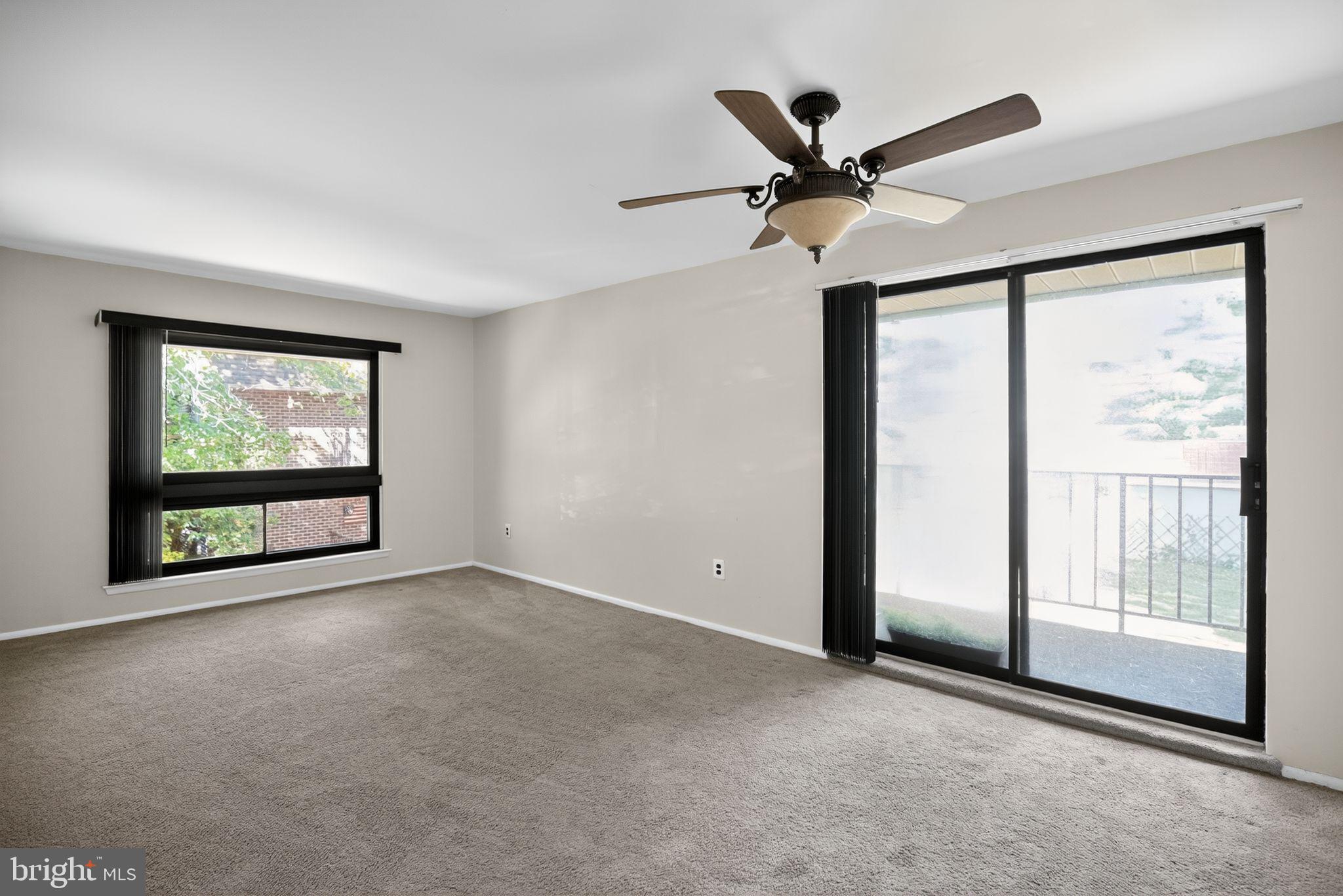 356 B Saybrook Lane, Unit B Wallingford, PA 19086 - Photo 7 of 34 an empty room with ceiling fan and window