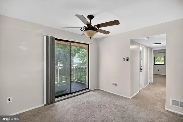 a view of n empty room with a ceiling fan